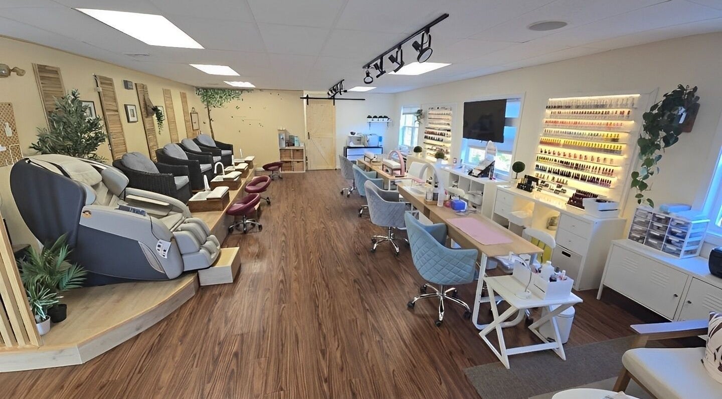 Modern interior of K-Beauty Nail & Spa in Maynard, Massachusetts, US, showcasing sleek nail stations and seating.
