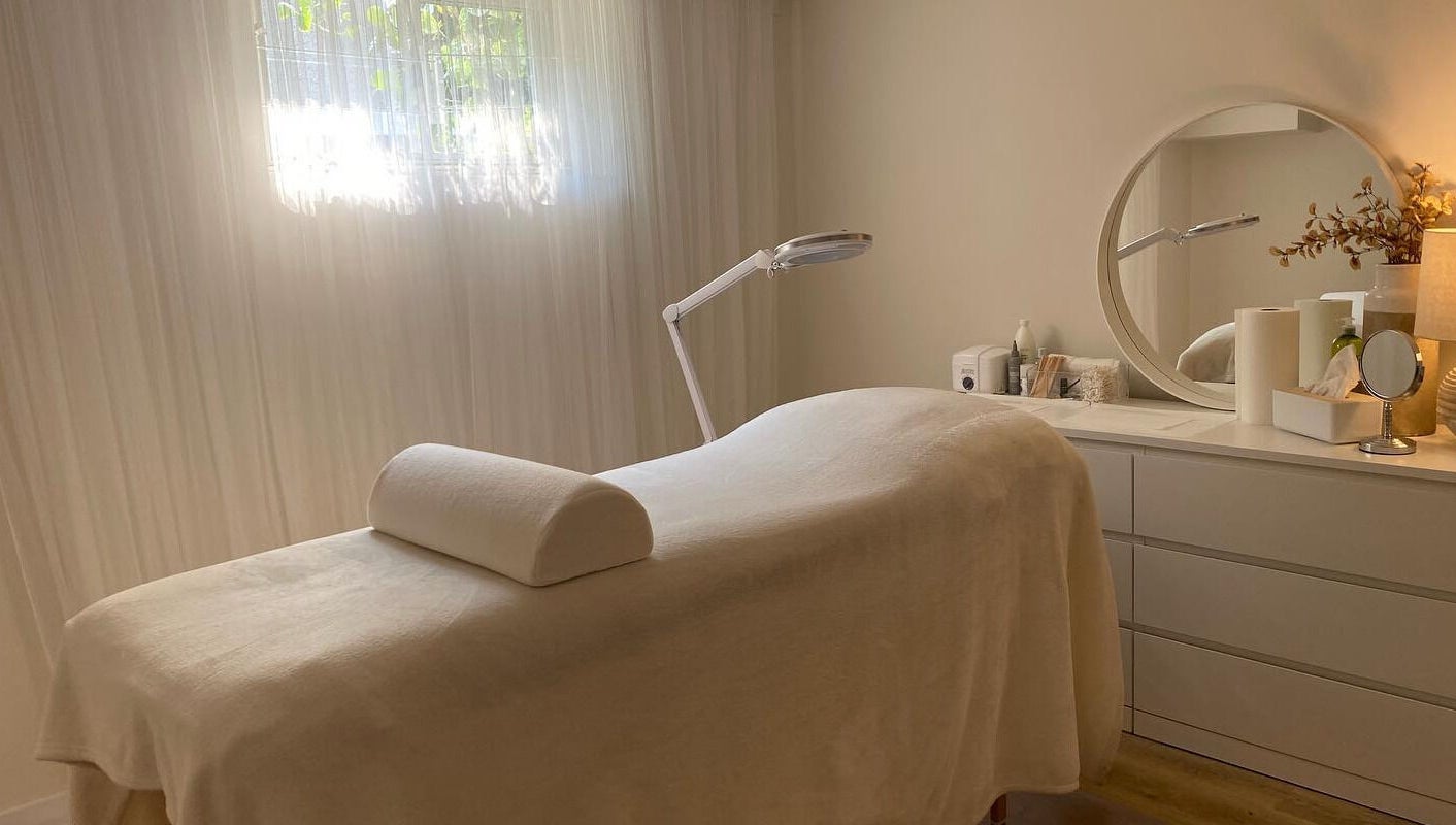 Relaxing treatment room at The Natural Brow, Edmonton, Alberta, CA, with a massage table and soothing decor.