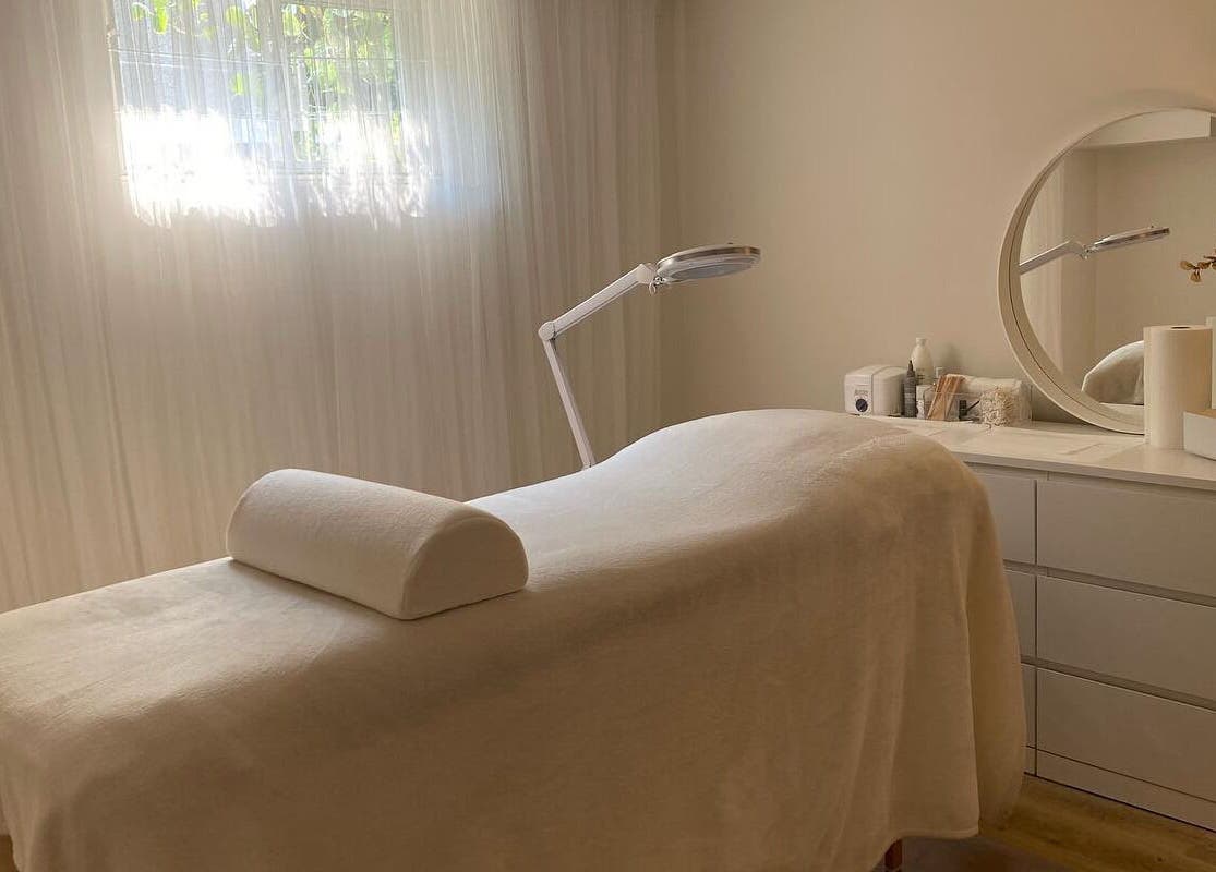 Relaxing treatment room at The Natural Brow, Edmonton, Alberta, CA, with a massage table and soothing decor.