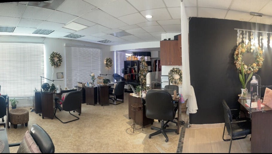 Elegant interior of Nail Gallery & Beauty Bar in Nassau, New Providence, BS with decorated workstations.