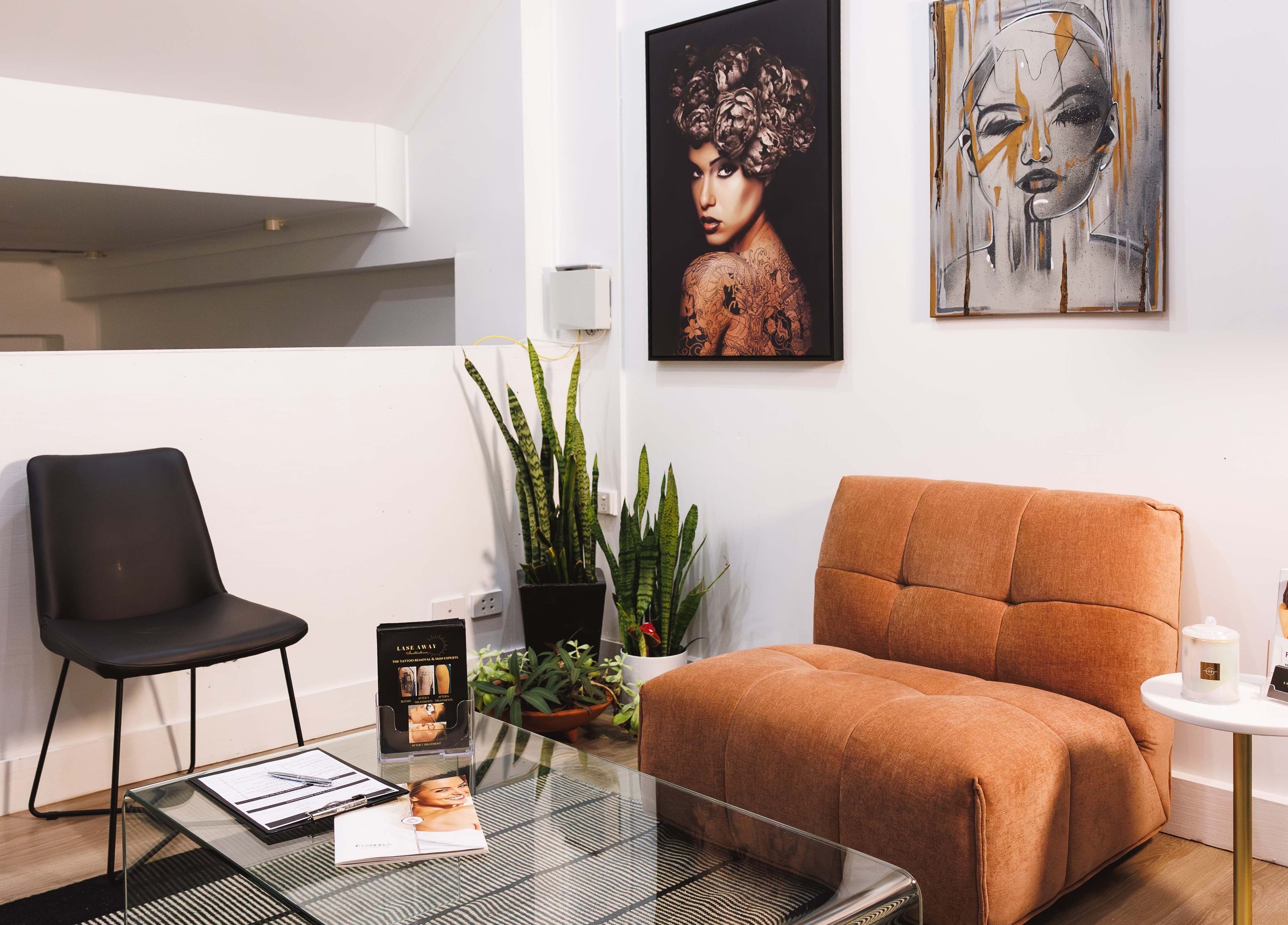 Lase Away's chic lounge in Coffs Harbour, New South Wales with modern decor and artful wall portraits.