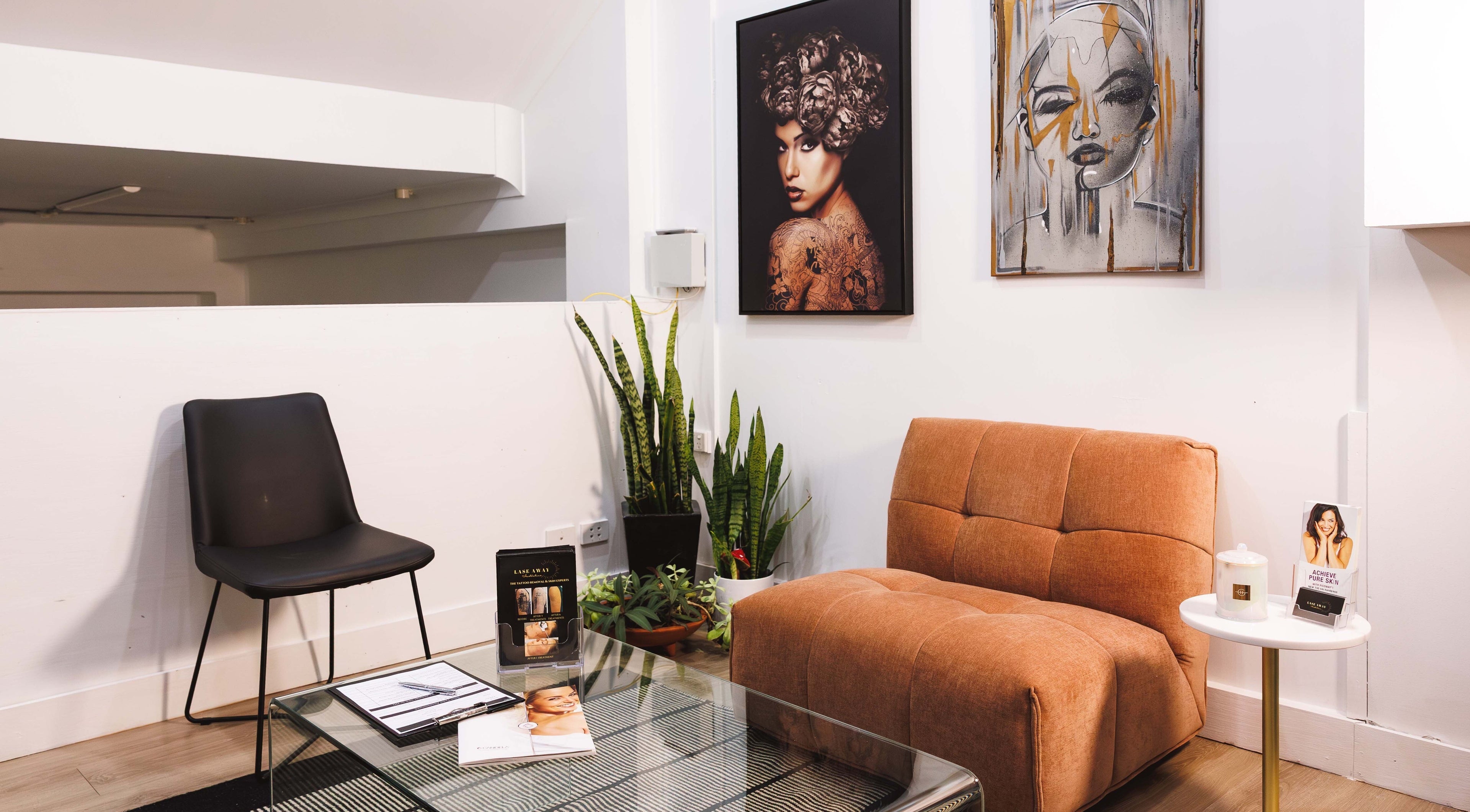 Lase Away's chic lounge in Coffs Harbour, New South Wales with modern decor and artful wall portraits.
