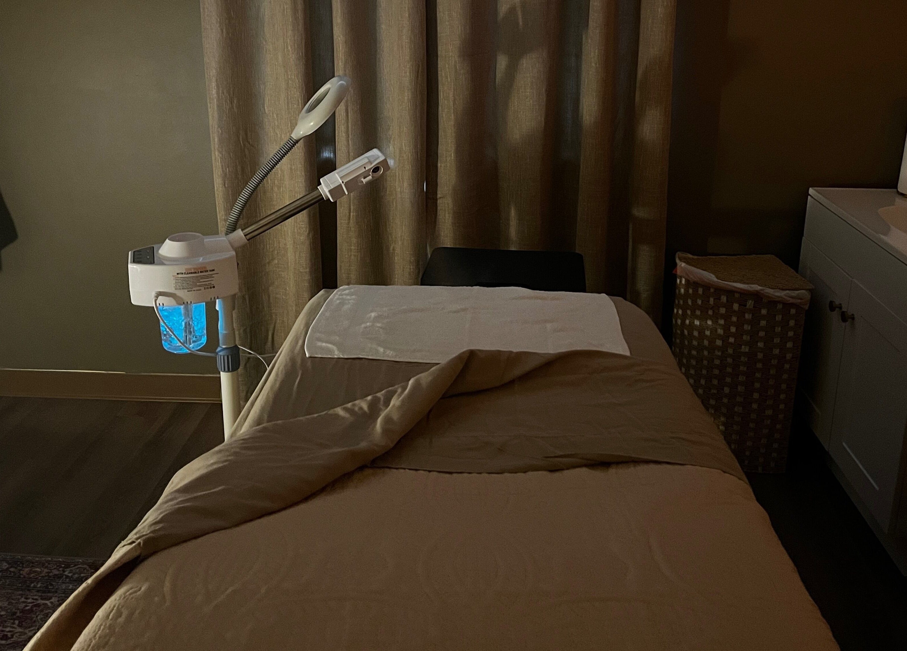 Tranquil treatment room at Immaculate Skin in Santa Fe, New Mexico, US, featuring massage bed and equipment.