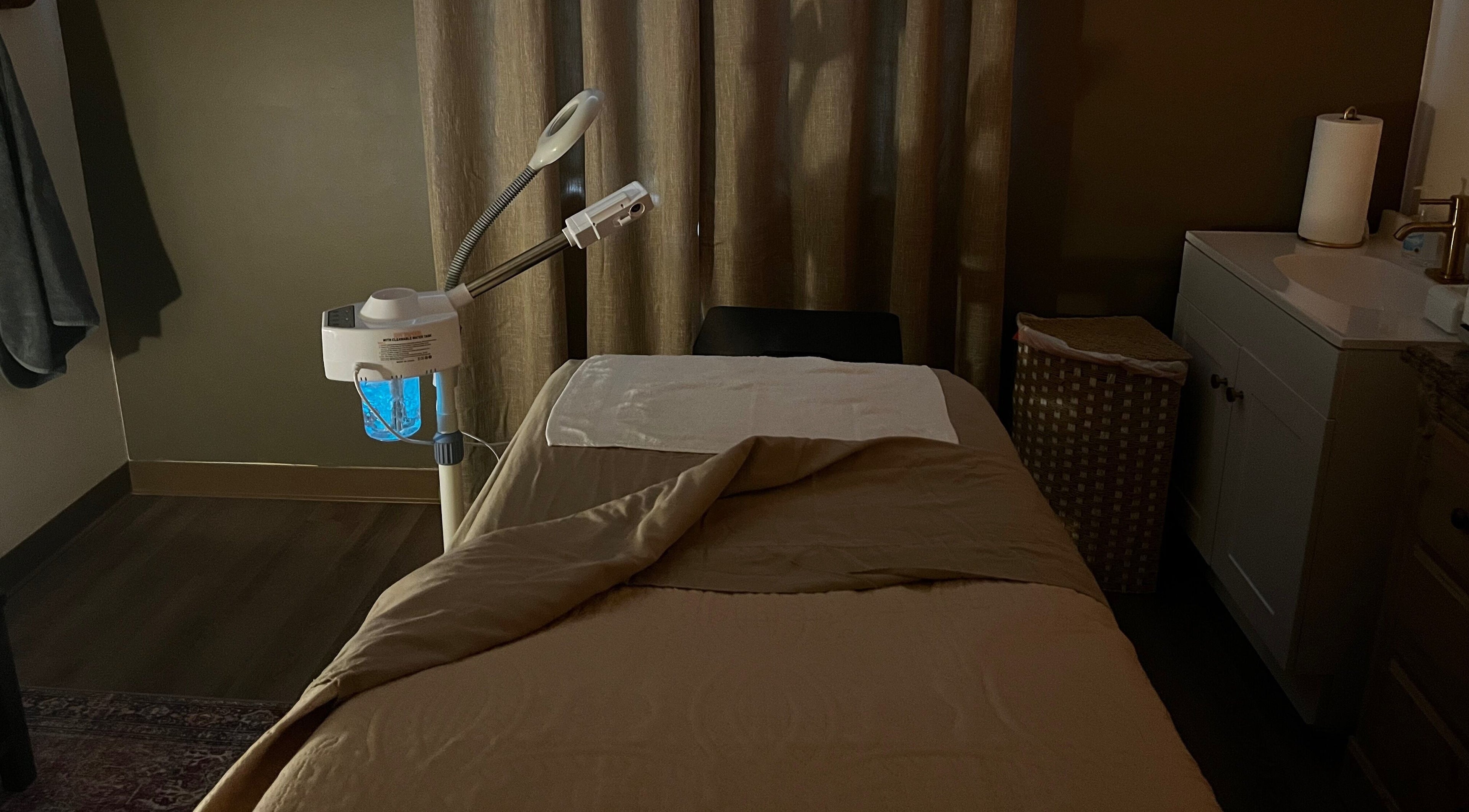 Tranquil treatment room at Immaculate Skin in Santa Fe, New Mexico, US, featuring massage bed and equipment.