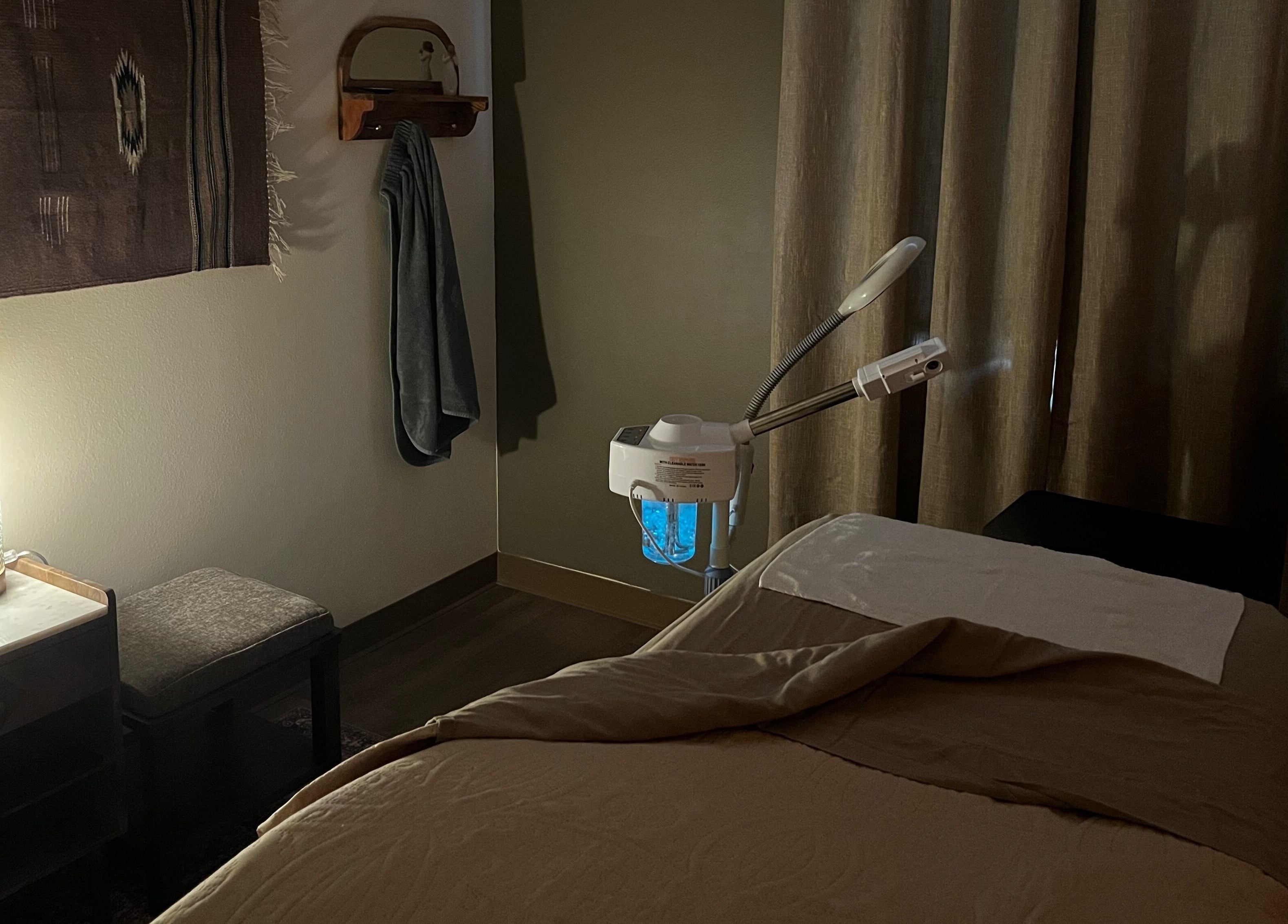 Cozy treatment room at Immaculate Skin in Santa Fe, New Mexico, US with a massage table and soft lighting.