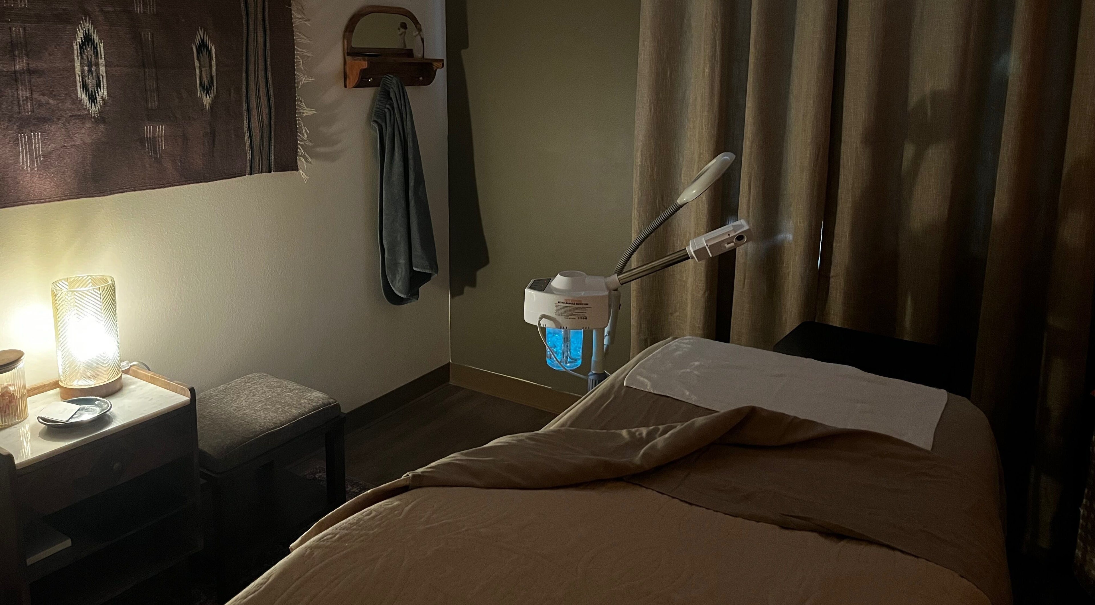 Cozy treatment room at Immaculate Skin in Santa Fe, New Mexico, US with a massage table and soft lighting.