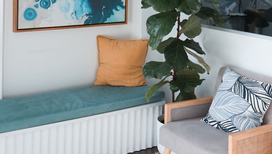 Cozy seating area at Daline Nails, Dee Why, New South Wales, AU with cushions and a leafy plant.