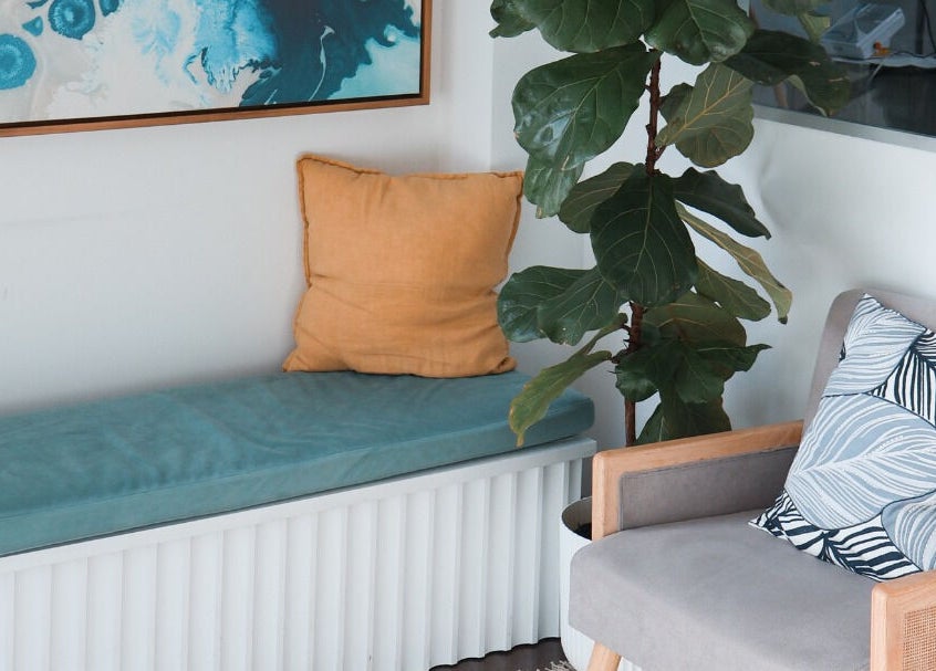 Cozy seating area at Daline Nails, Dee Why, New South Wales, AU with cushions and a leafy plant.