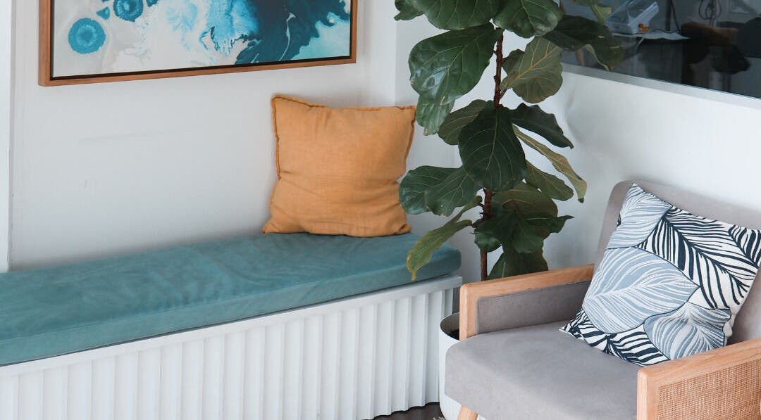 Cozy seating area at Daline Nails, Dee Why, New South Wales, AU with cushions and a leafy plant.