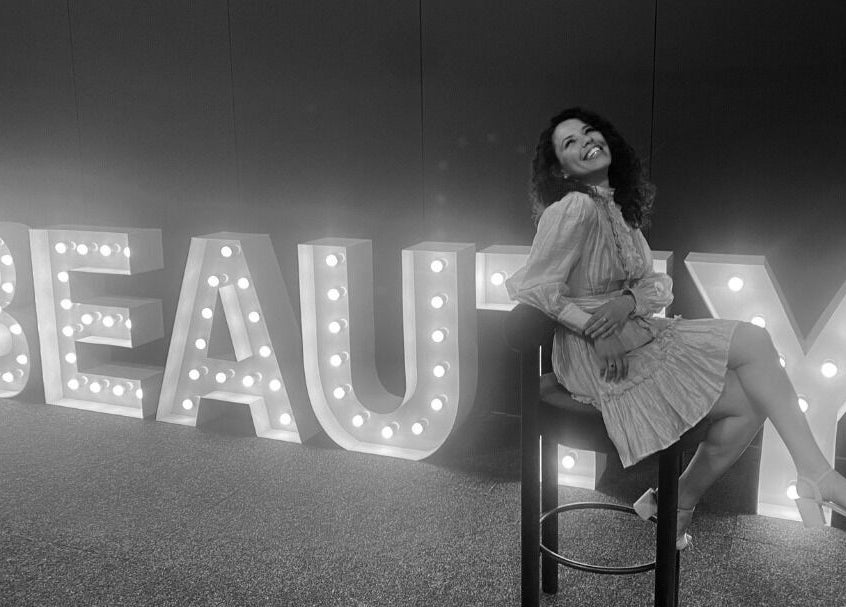 Illuminated beauty sign and smiling woman at Daline Nails, Dee Why, New South Wales, AU.