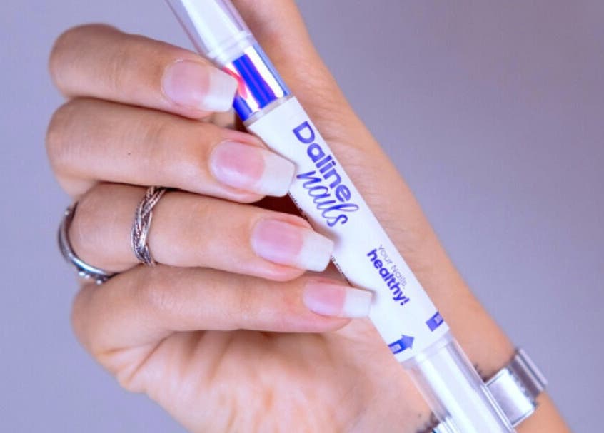 Hand holding Daline Nails pen for nail health at Daline Nails, Dee Why, New South Wales, AU.