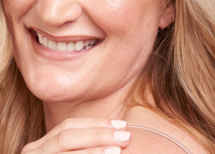 A woman smiles warmly, showcasing her nails, styled by Daline Nails in Dee Why, New South Wales, AU.
