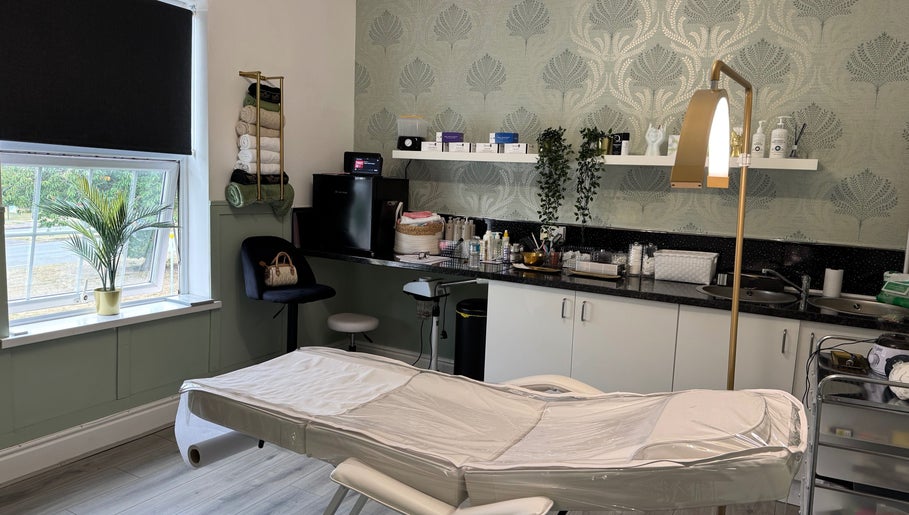 Stylish treatment room at Saving Face Aesthetics & Beauty, Warrington, England, GB, featuring a cozy setting.