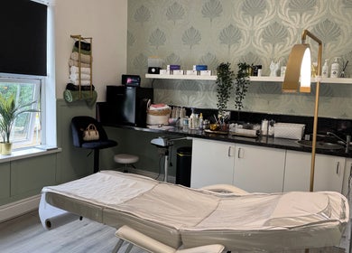 Stylish treatment room at Saving Face Aesthetics & Beauty, Warrington, England, GB, featuring a cozy setting.