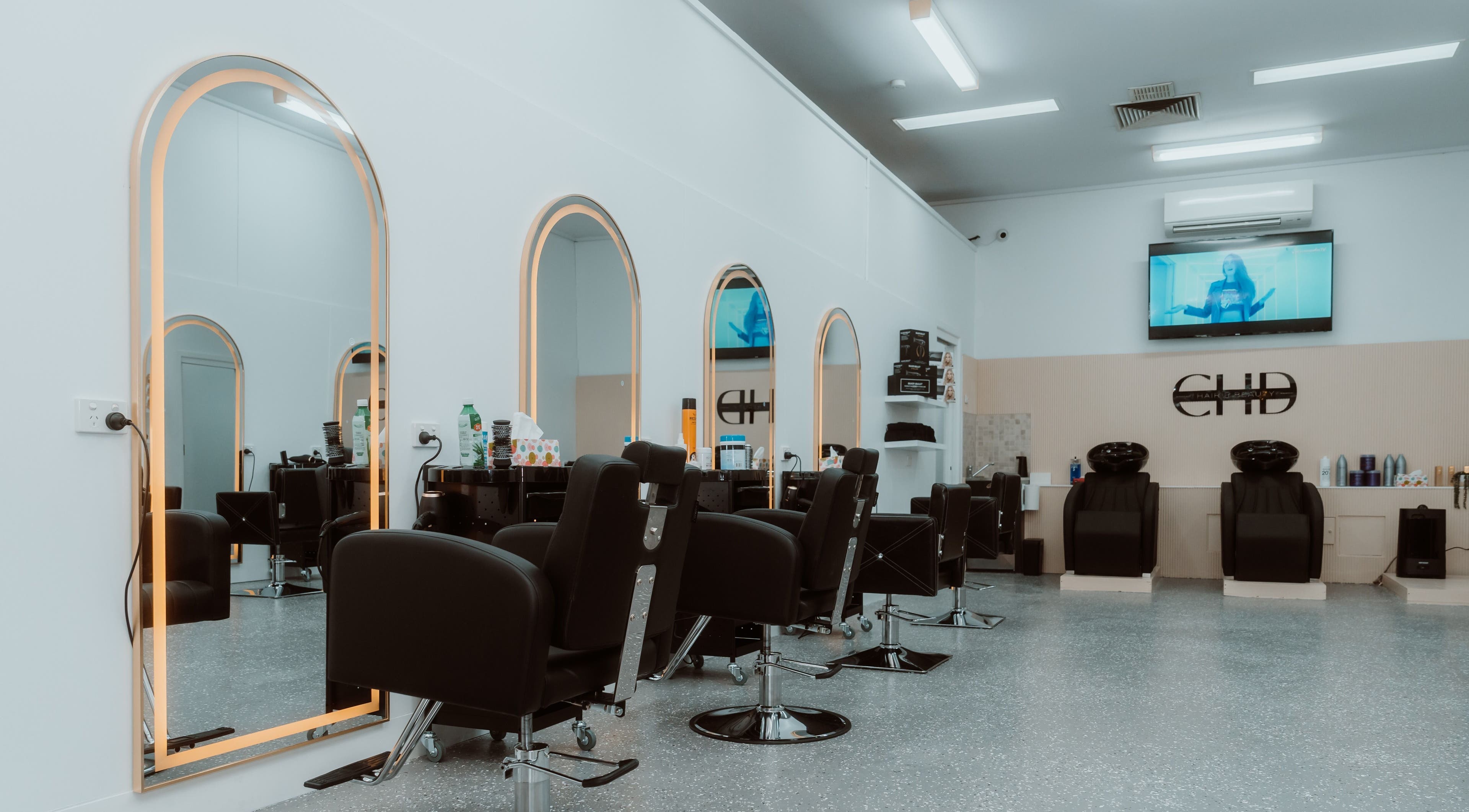 Inside CHD Hair & Beauty, Melbourne, Victoria, AU showcasing sleek styling chairs and mirrors.