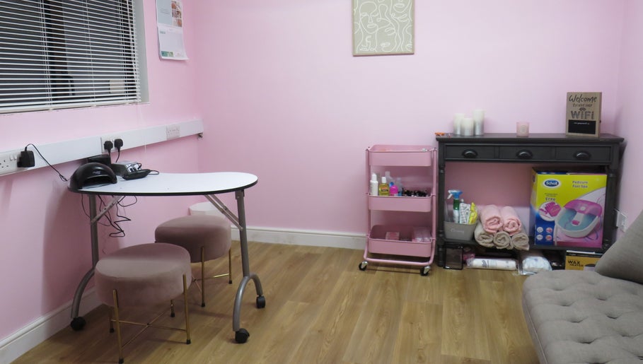 Chic beauty room at Enchanted By Em, Narborough, England, GB. Features pink decor and stylish seating.
