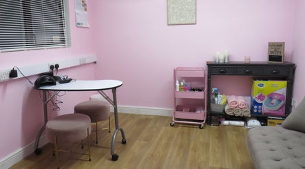 Chic beauty room at Enchanted By Em, Narborough, England, GB. Features pink decor and stylish seating.