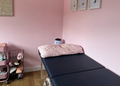 Treatment bed and supplies at Enchanted By Em in Narborough, England, GB. Inviting wellness space.