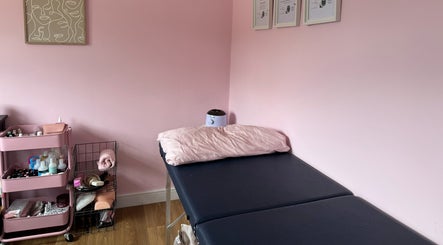 Treatment bed and supplies at Enchanted By Em in Narborough, England, GB. Inviting wellness space.