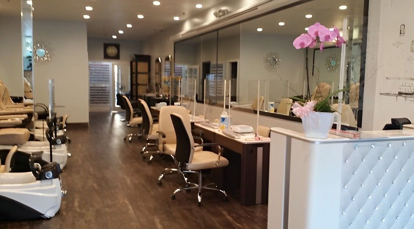 Interior of T Nail Salon in Santa Clara, California, US with elegant chairs and pink orchids.