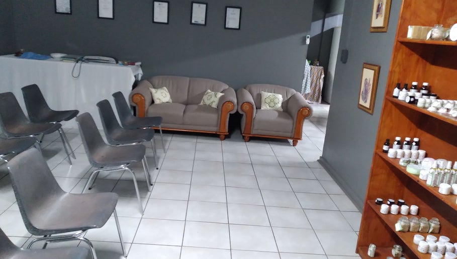 Cozy seating arrangement at MLM venue in Kathu, Northern Cape, ZA with skincare products displayed.