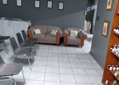 Cozy seating arrangement at MLM venue in Kathu, Northern Cape, ZA with skincare products displayed.