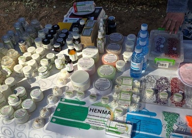 Display of handmade wellness products at MLM, Kathu, Northern Cape, ZA. Jars and bottles on a table.