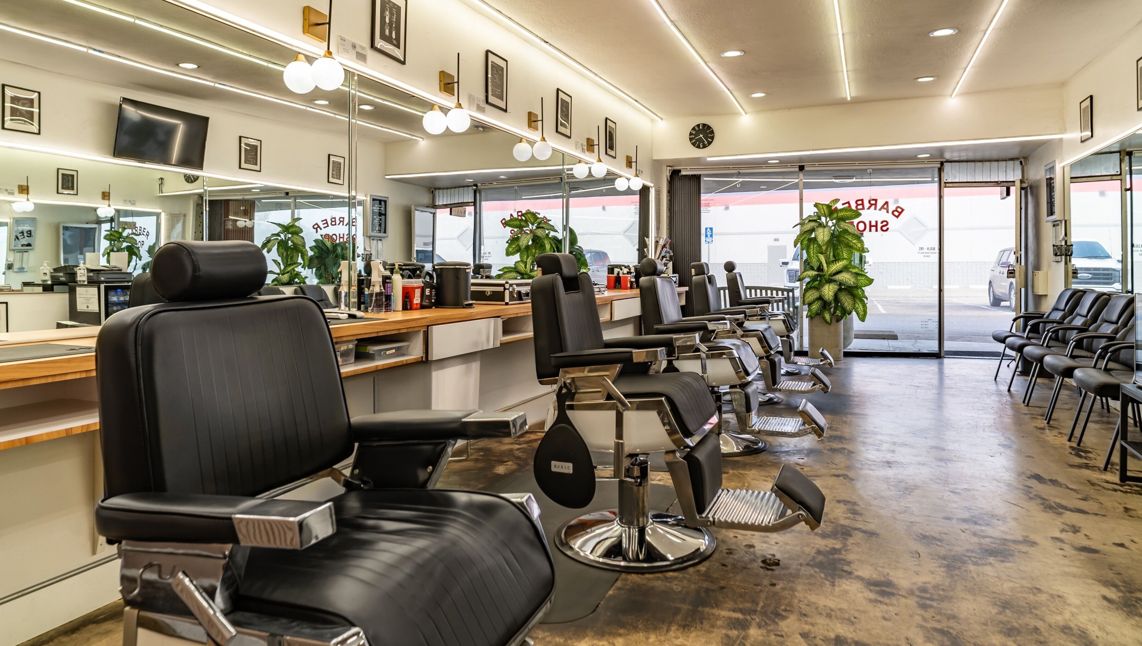 Interior of Basic Barber in Costa Mesa, California, US, featuring sleek black chairs and modern decor.