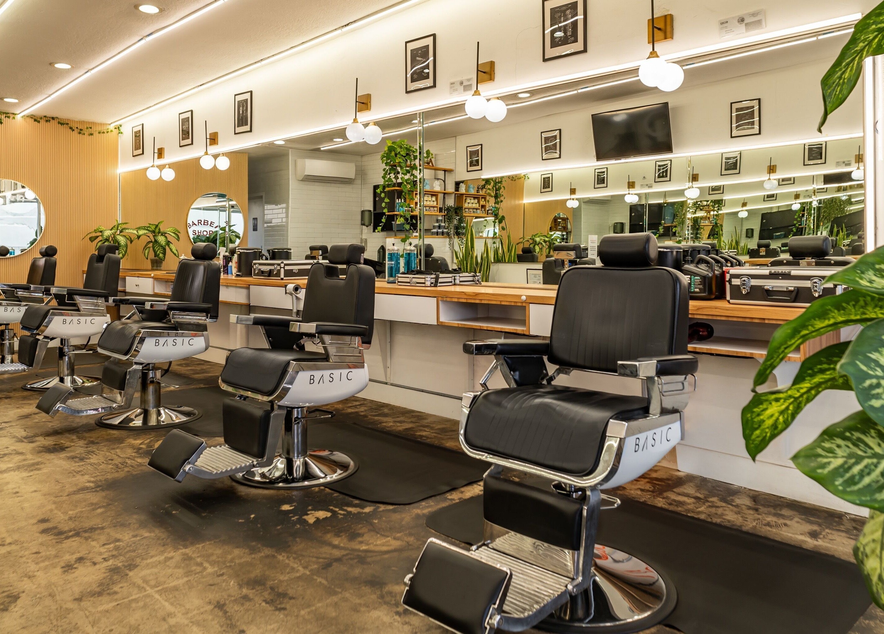 Spacious seating at Basic Barber in Costa Mesa, California, US with stylish decor and modern lighting.