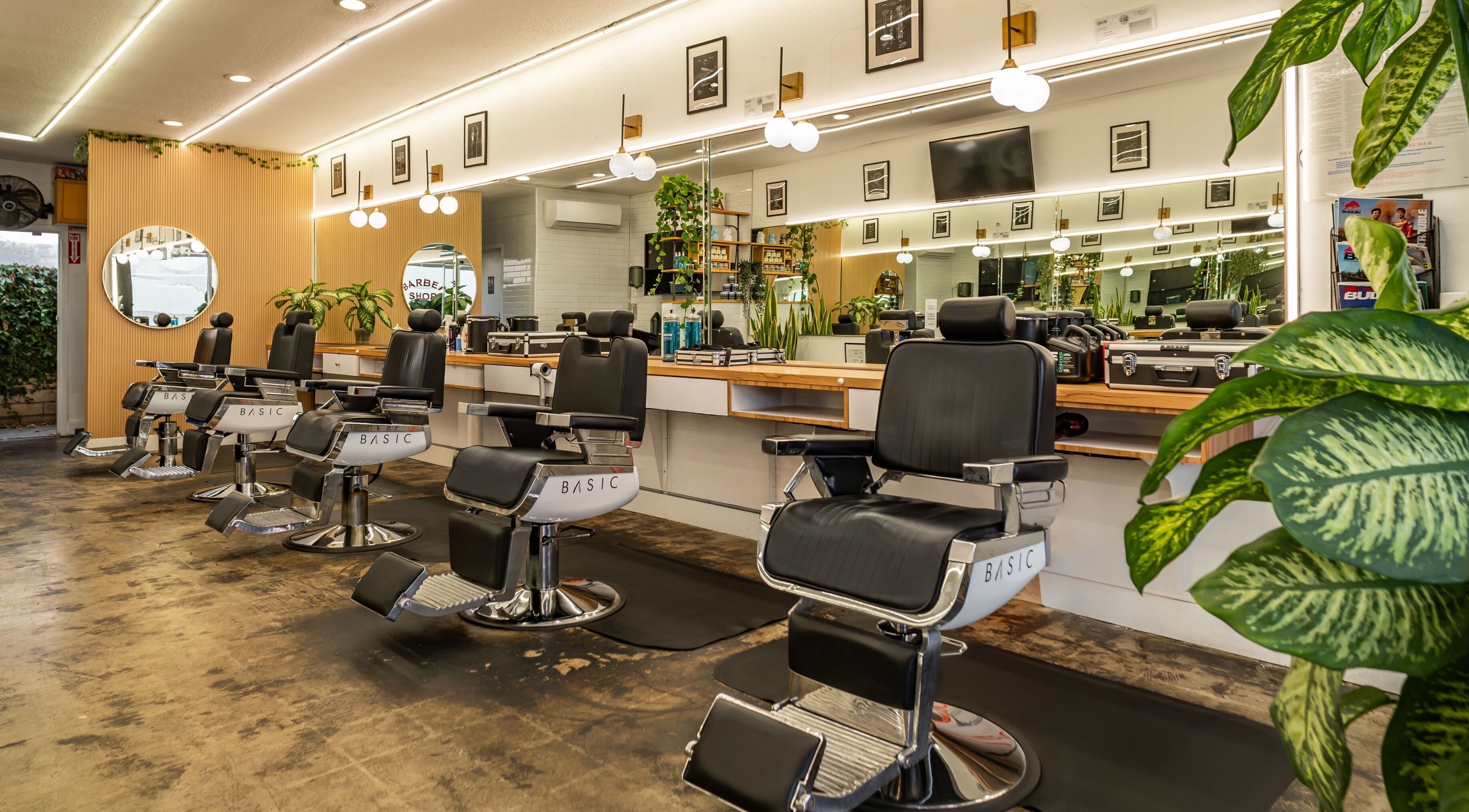 Spacious seating at Basic Barber in Costa Mesa, California, US with stylish decor and modern lighting.