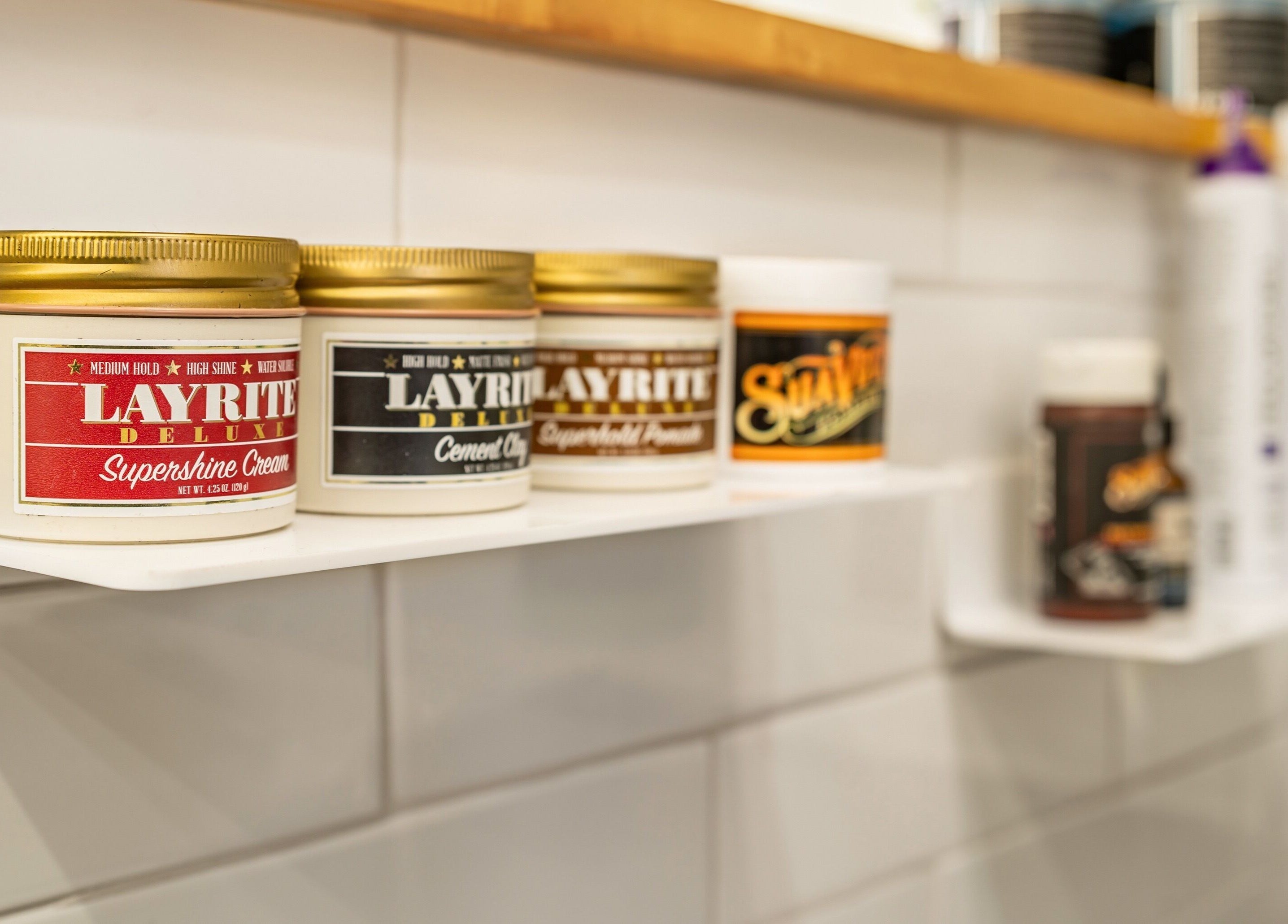 Styling products at Basic Barber, Costa Mesa, California, US, showcasing premium hair care offerings.