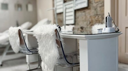 A chic nail salon setup at Nails by Amelia, Baildon, England, GB with white fur chairs and modern decor.