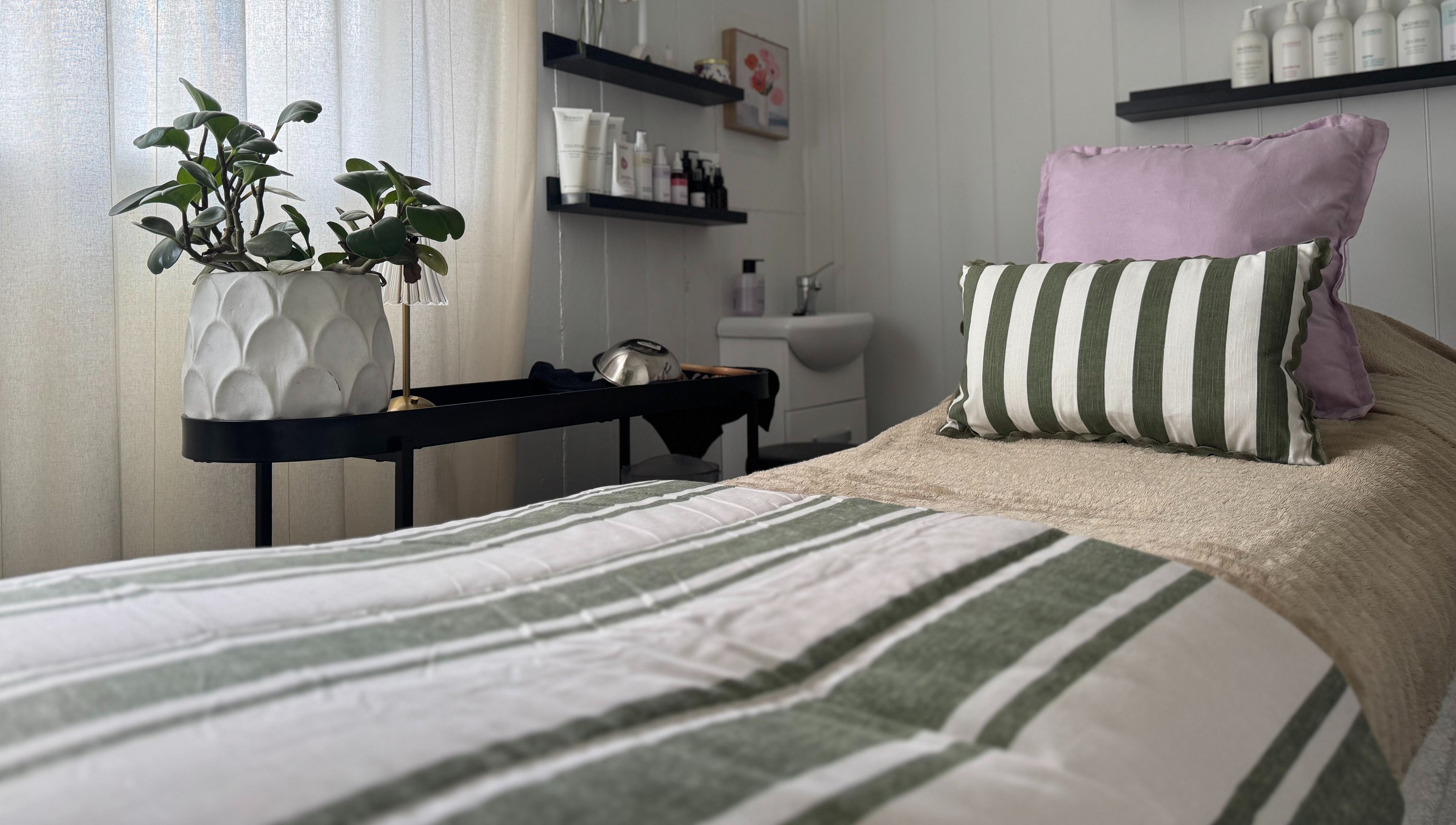 Calming massage bed at Babotanics Boutique in Paddington, Queensland, AU, with cozy decor and greenery.
