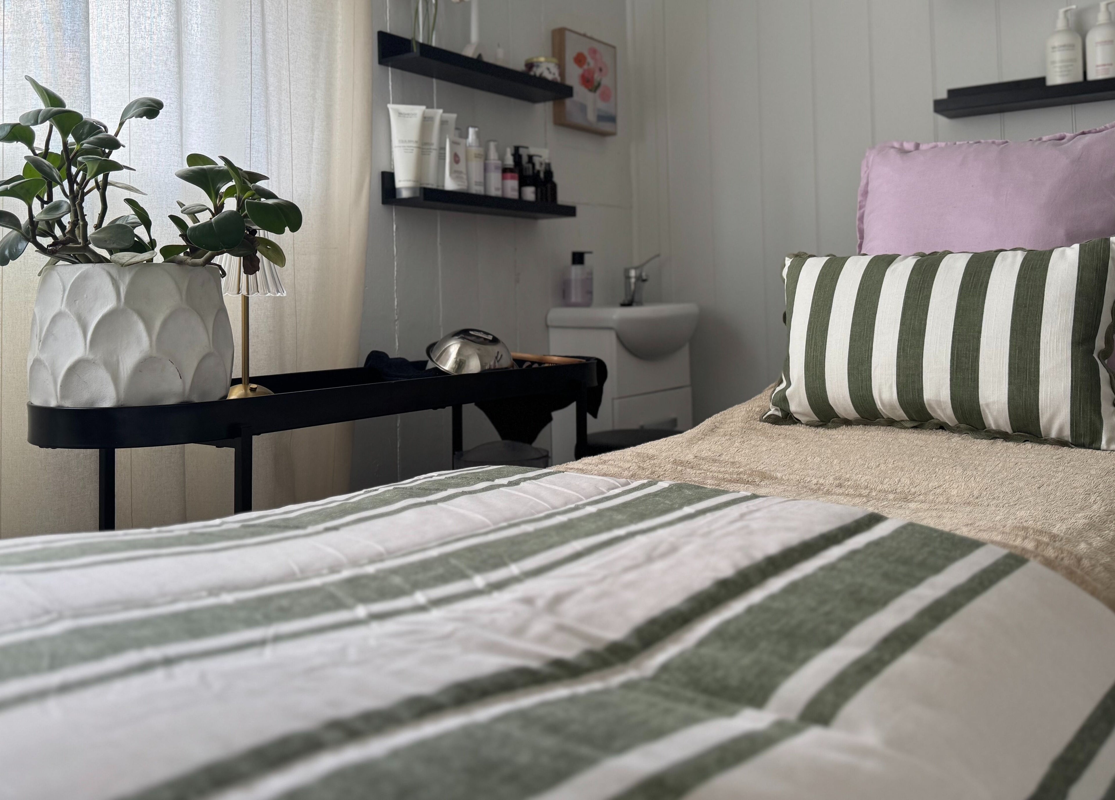 Calming massage bed at Babotanics Boutique in Paddington, Queensland, AU, with cozy decor and greenery.
