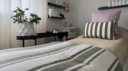 Calming massage bed at Babotanics Boutique in Paddington, Queensland, AU, with cozy decor and greenery.