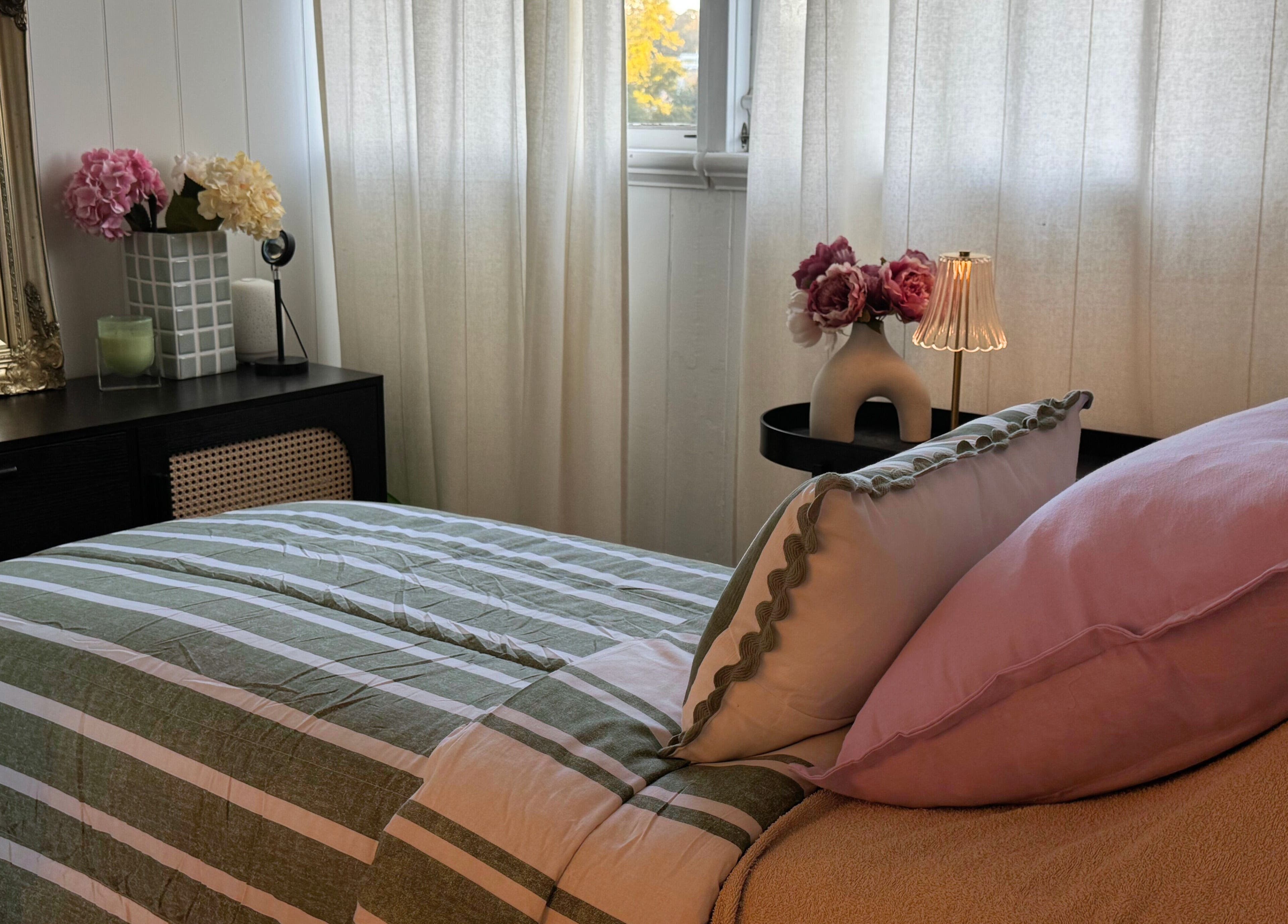 Elegant bedroom at Babotanics Boutique, Paddington, Queensland, AU with floral decor and soft lighting.