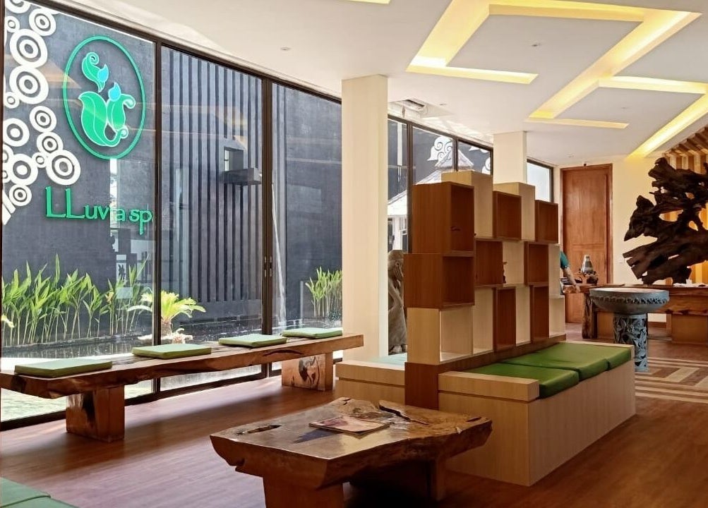 Elegant lobby of LLuvia Spa Bali featuring natural wood decor and green accents in Bali, Bali, ID.