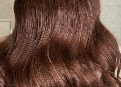 Glossy brunette waves styled at Molly Grace Hair in Market Bosworth, England, GB. Perfect for a chic look.
