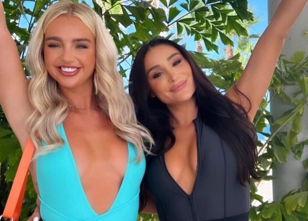 Two women smiling outdoors, showcasing styles by Ibiza Hair & Makeup Mobile, Ibiza, GB.