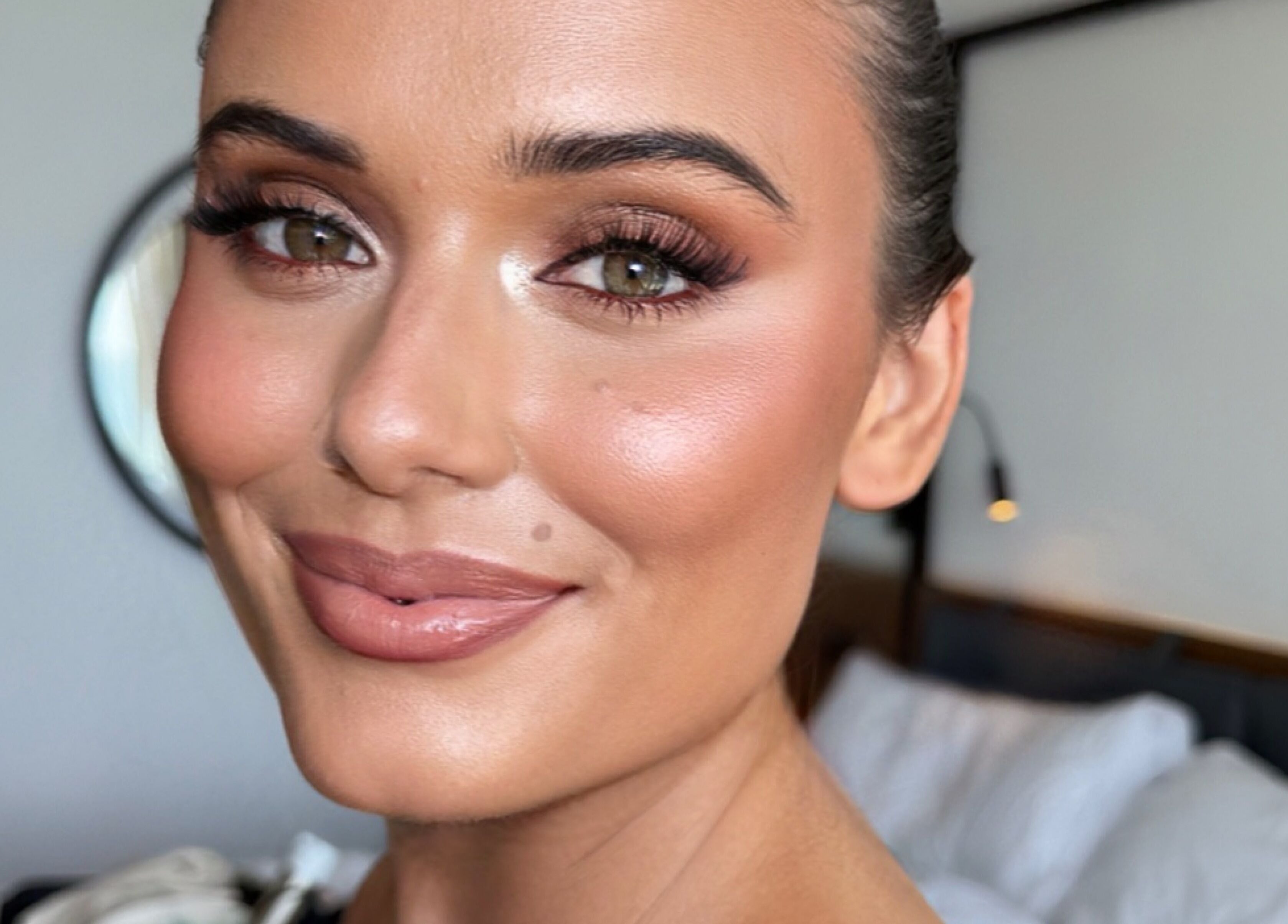 A woman with flawless makeup by Ibiza Hair & Makeup Mobile in Ibiza, GB, showcasing perfect complexion.