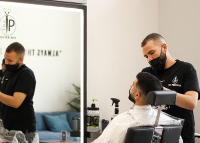 Barber styling a client's hair at The Protocol Barbershop, Riyadh, Riyadh Province, SA.