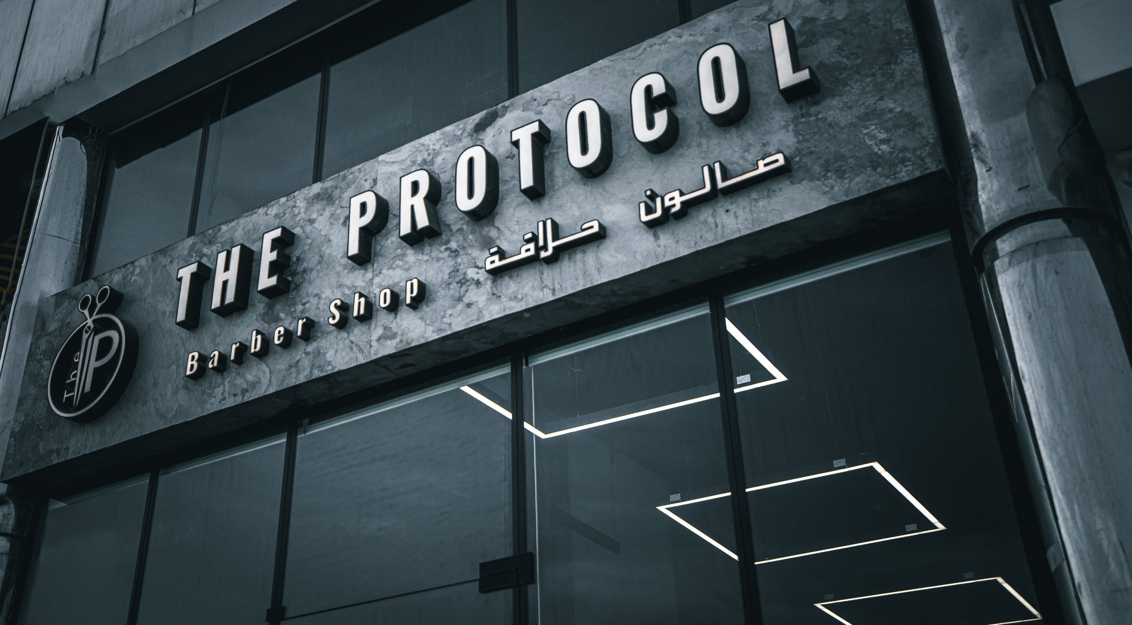Entrance of The Protocol Barbershop in Riyadh, Riyadh Province, SA with modern design and signage.