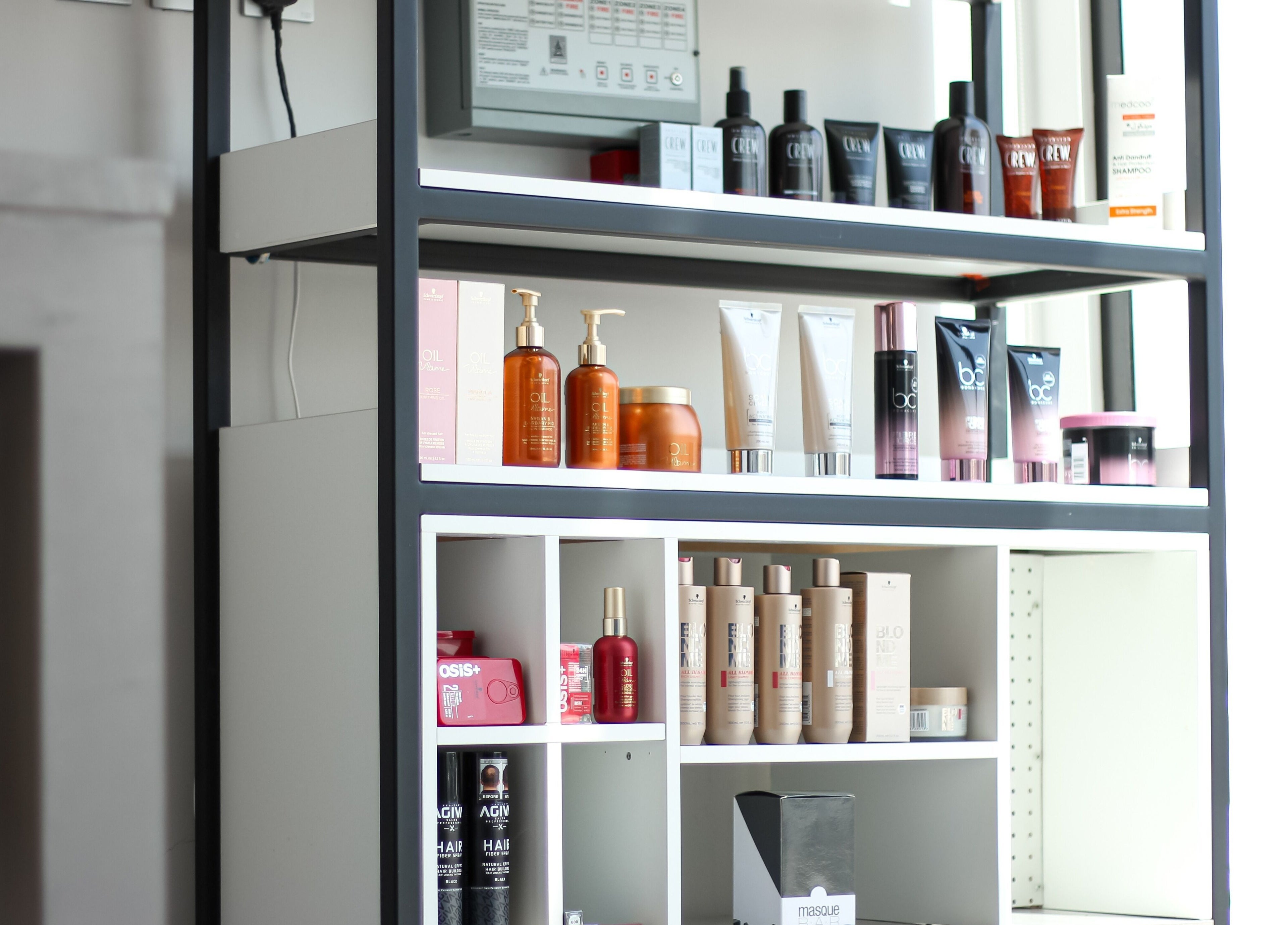 Product display shelf at The Protocol Barbershop, Riyadh, Riyadh Province, SA featuring haircare items.