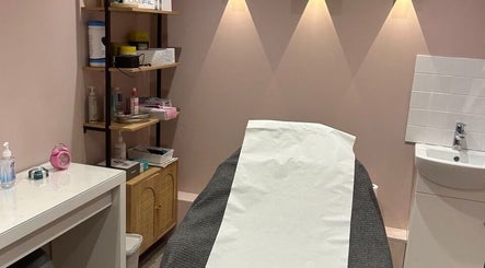 Cozy treatment room at Modern Goddess Zone in Brighton And Hove, England, GB. Shelves with wellness products.