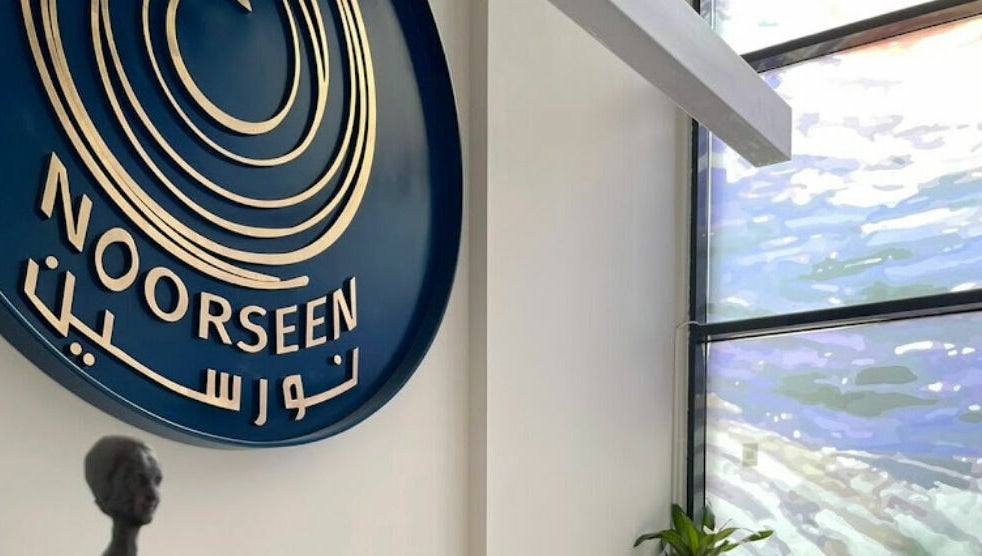 Elegant sign of Noorseen Spa - King Faisal at Distract, Riyadh Province, SA near a modern window.