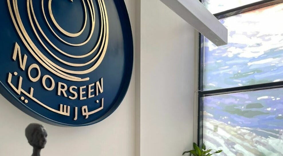 Elegant sign of Noorseen Spa - King Faisal at Distract, Riyadh Province, SA near a modern window.