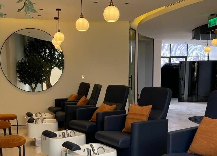 Luxurious seating area at نورسين سبا - الملك فيصل, Distract, Riyadh Province, SA with chic pedicure stations.