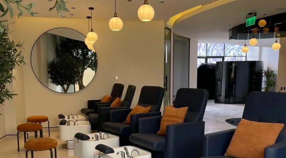 Luxurious seating area at نورسين سبا - الملك فيصل, Distract, Riyadh Province, SA with chic pedicure stations.