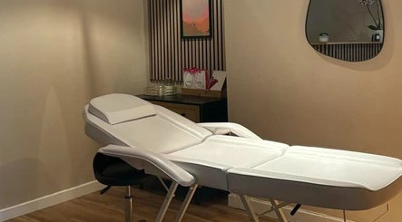 Relaxing spa treatment room at The Olive Room Hereford in Hereford, England, GB with massage table and soft lighting.