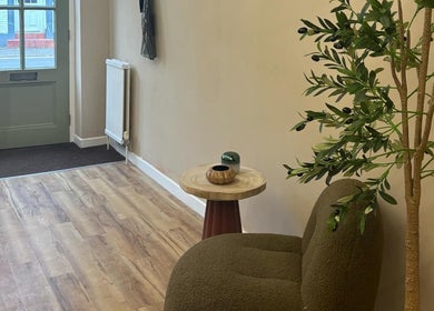 Welcoming entrance at The Olive Room Hereford, Hereford, England, GB with a cozy chair and olive plant.